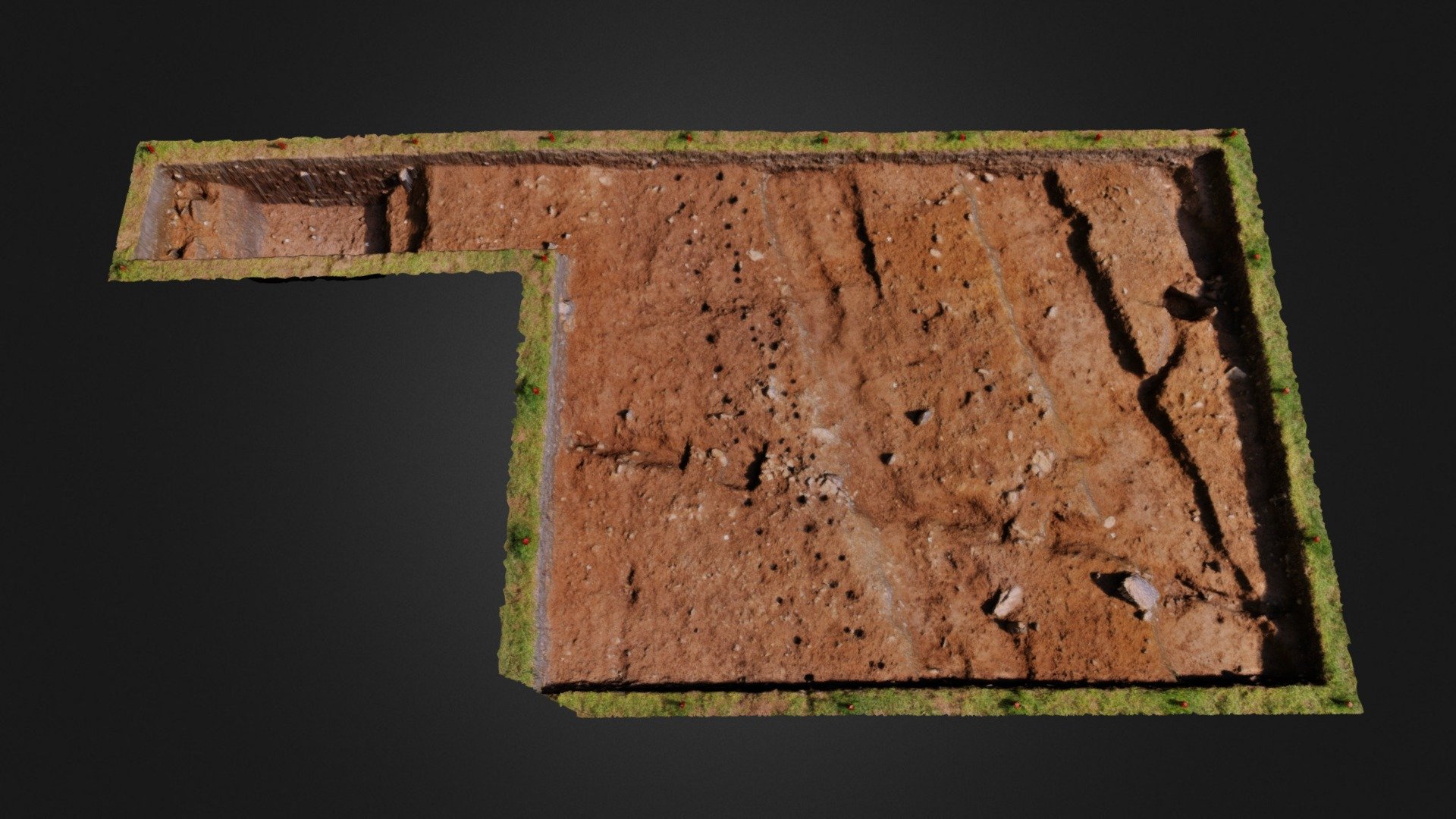 This model was captured following excavation of Trench 5 at Lisnamanore (CO084-084), Garranes, Co. Cork. Some 33 cubic metres of material was carefully removed by students of the MA in Archaeological Excavation (2013/14) to reveal the surface now exposed.  This enclosure is some 65 metres in diameter and was originally enclosed by a stake/post fence and external ditch (approx. 1.25 metres deep). Note the linear arrangement of stakeholes marking the line of the fence. Two wide trenches running parallel across the surface are the remains of more recent cultivation (ridge-and-furrow) and have cut across earlier trench features. This site has been dated to the later part of the 5th Century AD. Approx 100m to the E is the well-known Garranes trivallate ringfort. 
This trench has been back-filled and the site now fully reinstated. The model was generated using Agisoft with some further processing in MeshLab. It has been scaled (red pegs 2m apart) and the viewer is looking N on opening. This site is on private land 3d model