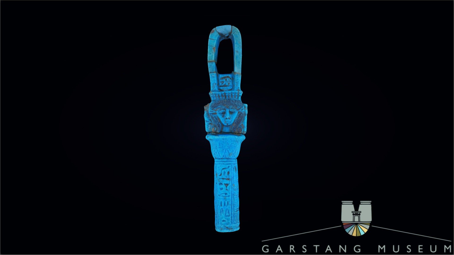 An ancient Egyptian arched sistrum (musical percussion instrument similar to a rattle). The provenance is unknown as the piece was purchased in Luxor in 1908. It likely dates to the Late Period.

The sistrum is pierced twice on each side of the arch where the moving pieces would have been inserted. Below the arch, we see a wedjat eye above a nb-sign. Hathor's head is flanked by two columns and bears her characteristic plaited wig. This example is unusual for the lack of a double headed Hathor, only one side bears Hathor's face with the back of the sistrum featuring the sun disk and horns (Hathor's symbol).

The inscription reads &ldquo;Words spoken by Bastet-Iru-Di-Set